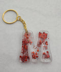 M 'Groovy' Keychain- Clear with Red Glitter