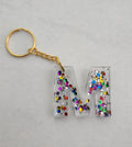 M Keychain- Clear with Rainbow Glitter