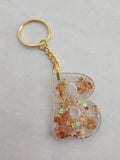 B 'Groovy' Keychain- Clear with Orange Glitter