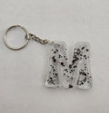 M 'Groovy' Keychain- Clear with Black Glitter
