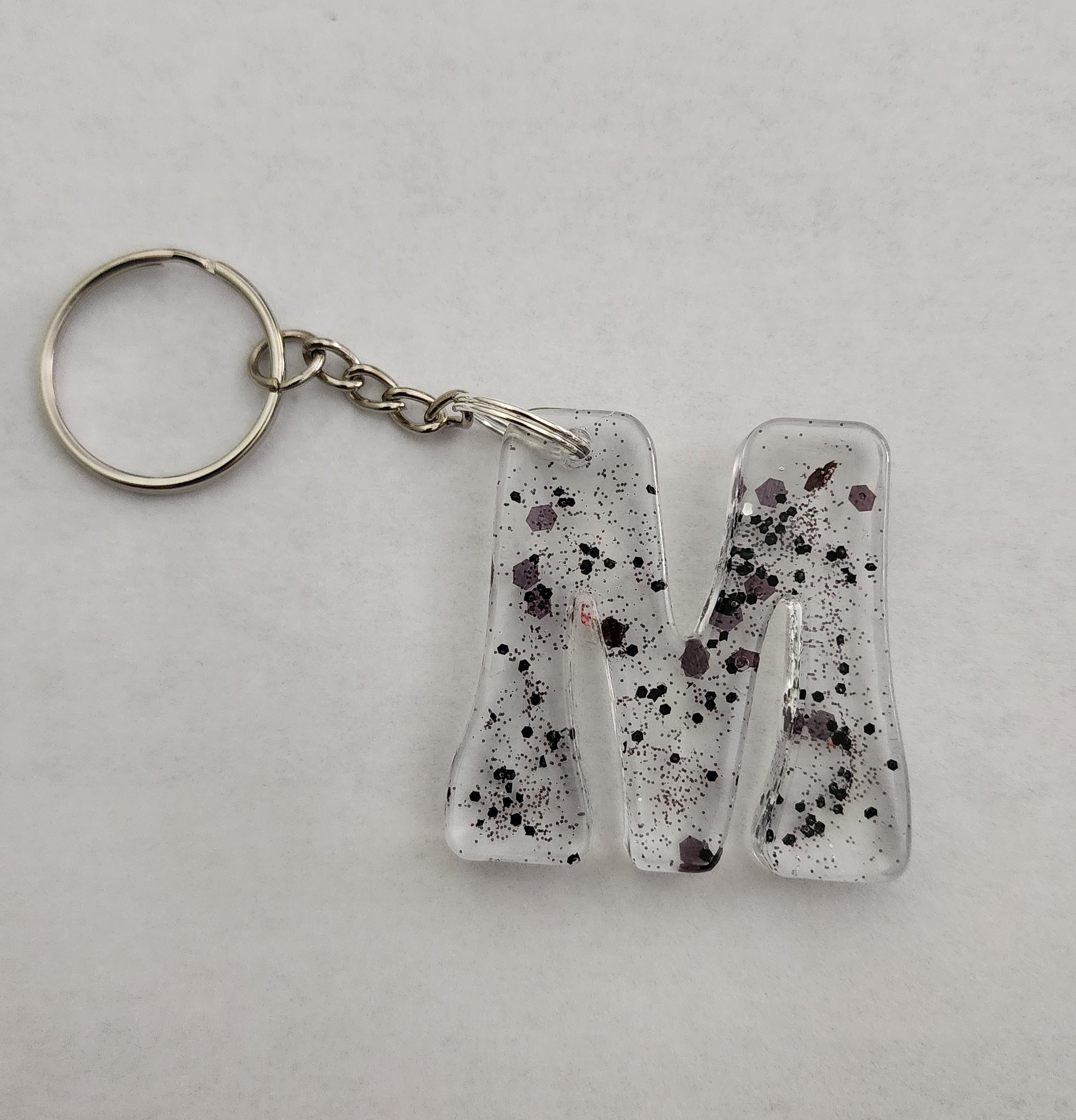 M 'Groovy' Keychain- Clear with Black Glitter