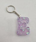 E 'Groovy' Keychain With Iridescent Glitter